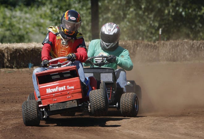 Ken Elder gets up on two wheels while being pursued by Josh Woelke in a CP Class lawnmower race held at the Oakridge Old Mill Raceway at the Oakridge Industrial Park in Oakridge on Monday, February 16, 2015. The race was one of several held at the new racing venue and was attended by teams from throughout the region. Elder won the heat but Woelke came back to win the main event race later in the day. (Andy Nelson/The Register-Guard)