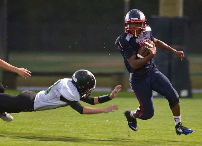 PETER.WILLOTT@STAUGUSTINE.COM Beacon of Hope Christian's JJ Pinkney runs the ball in the school's game against Eagle's View Academy on Friday, Sept. 26, 2014.