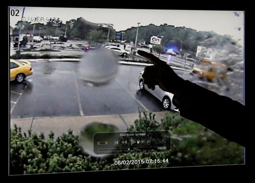 First Assistant Suffolk County District Attorney Patrick Haggan points to surveillance video released during a press conference Monday, June 8, 2015, in Boston, which they say shows the fatal shooting of a Boston man suspected of plotting to kill police officers. The video comes from a restaurant across the street, and the figures shown are blurry. Police and the FBI say it shows officers shooting 26-year-old Usaama Rahim on June 2 in the city's Roslindale neighborhood after they attempted to question him about "terrorist-related information." (AP Photo/Elise Amendola)