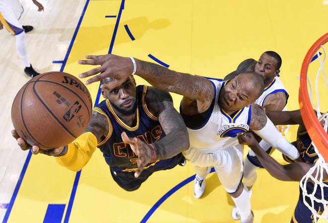 Cleveland Cavaliers forward LeBron James, left, shoots against Golden State Warriors forward Marreese Speights during the first half of Game 2 of basketball's NBA Finals in Oakland, Calif., Sunday, June 7, 2015.