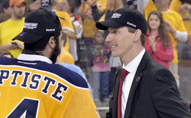 Erie Otters' Nicholas Baptiste congratulates coach Kris Knoblauch after the Otters won the OHL Western Conference finals with a 7-3 victory in Game 6 over the Sault Ste. Marie Greyhounds at Erie Insurance Arena on May 2 in Erie. ANDY COLWELL/