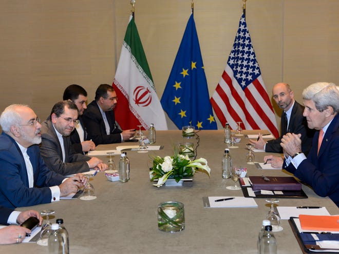 U.S. Secretary of State John Kerry, right, speaks with Iranian Foreign Minister Mohammad Javad Zarif, left, prior to a bilateral meeting for a new round of Nuclear Talks with Iran at the Intercontinental Hotel, in Geneva, Switzerland, Saturday, May 30, 2015. A month out from a nuclear deal deadline, the top U.S. and Iranian diplomats gathered in Geneva Saturday in an effort to bridge differences over how quickly to ease economic sanctions on Tehran and how significantly the Iranians must open up military facilities to international inspections.