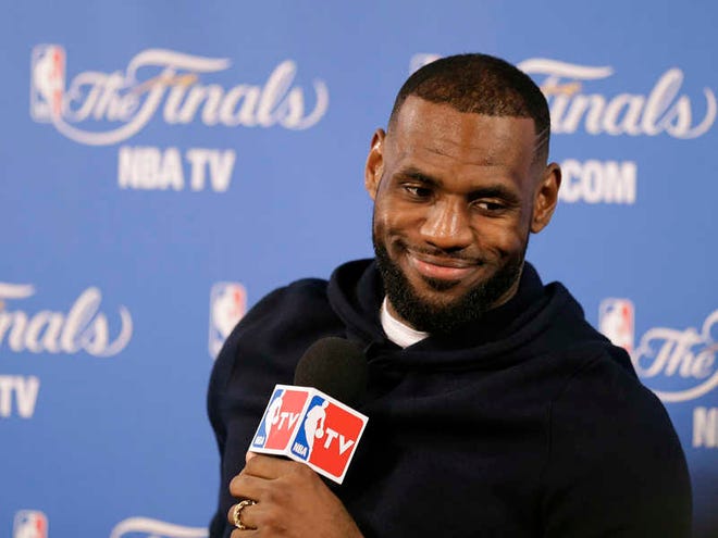 Cleveland Cavaliers forward LeBron James smiles during a news conference after Game 2 of basketball's NBA Finals Sunday, June 7, 2015, in Oakland, Calif. Cleveland won the game in 95-93 in overtime. (AP Photo/Ben Margot)