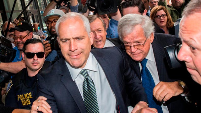 Former U.S. House Speaker Dennis Hastert, second from right, is led by Sidley Austin attorney John Gallo as they make their way through the media gathering at Chicago's Dirksen U.S. Courthouse on Tuesday, June 9, 2015. Hastert was in court for his arraignment on charges he evaded bank regulations and lied to the FBI. (Zbigniew Bzdak/Chicago Tribune/TNS)