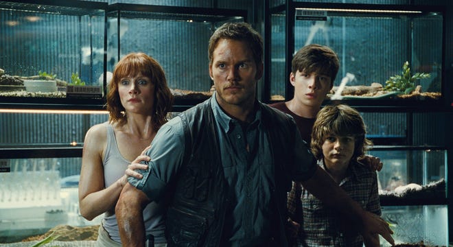 This photo provided by Universal Pictures shows Bryce Dallas Howard, from left, as Claire, Chris Pratt as Owen, Nick Robinson as Zach, and Ty Simpkins as Gray, in a scene from the film, "Jurassic World," directed by Colin Trevorrow.