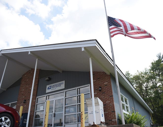 The U.S. flag at the Blakeslee Post Office is stuck in its current position until a service company can fix the pole to raise the flag into proper position.The flag is seen here Wednesday. (Amy Herzog/Pocono Record)