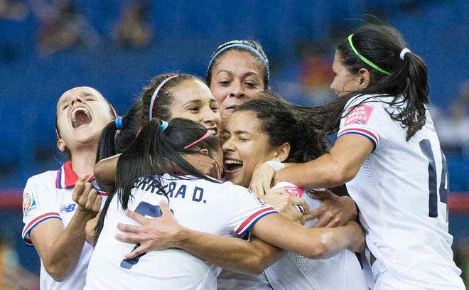 Costa Rica's Raquel Rodriguez Cedeno, second right, celebrates with teammates after scoring against Spain during the first half of a FIFA Women's World Cup soccer match in Montreal, Canada, Tuesday, June 9, 2015. (Graham Hughes/The Canadian Press via AP) MANDATORY CREDIT
