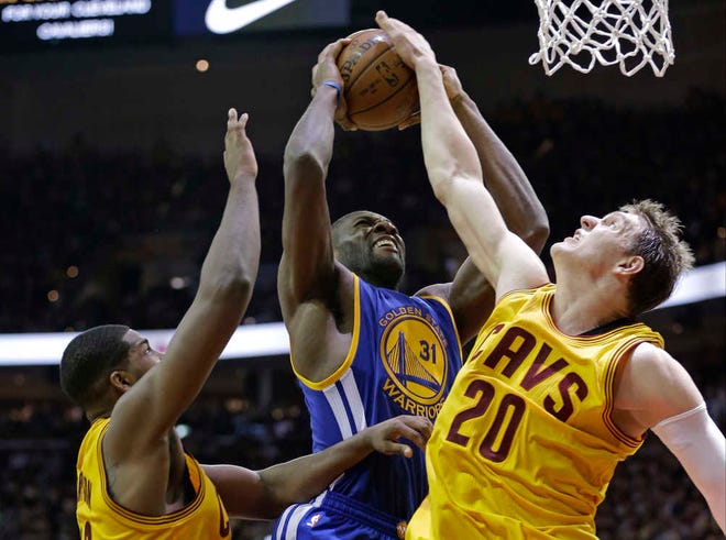 Golden State Warriors center Festus Ezeli has his shot blocked by Cleveland Cavaliers center Timofey Mozgov (20) as Tristan Thompson closes in during Game 3 of the NBA Finals on Tuesday in Cleveland. (AP Photo/Tony Dejak)