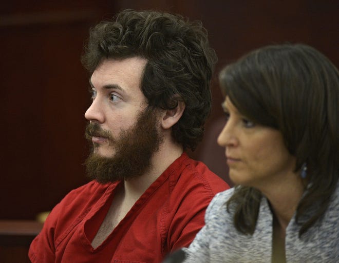 James Holmes, left, and defense attorney Tamara Brady appear in district court in Centennial, Colo., for his arraignment on March 12, 2013. RJ Sangosti/The Denver Post via AP, Pool, File