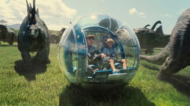 Nick Robinson, left, as Zach, and Ty Simpkins as Gray, in a scene from the film, "Jurassic World."