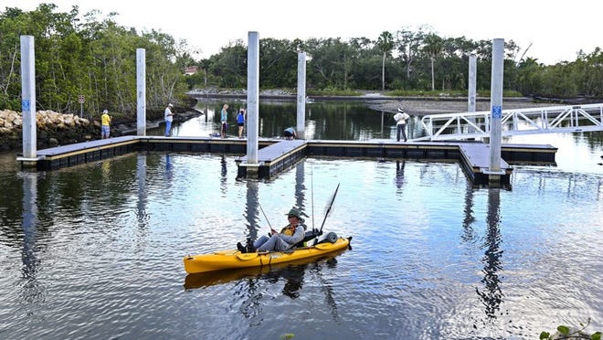 A fisherman kayaks past the new boat docks on Fullerton Island in Jupiter.PALM BEACH POST PHOTO LANNIS WATERS