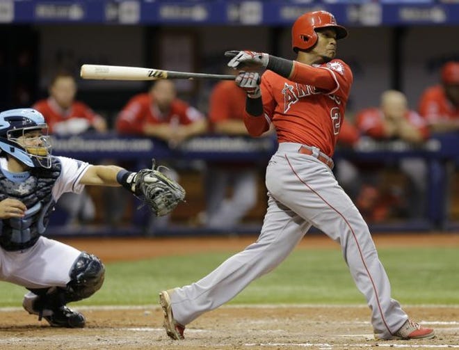 Los Angeles Angels' Erick Aybar hits into a fielder's choice against Tampa Bay Rays relief pitcher Brad Boxberger during the seventh inning of a baseball game Thursday, June 11, 2015, in St. Petersburg, Fla. Angels' Efren Navarro scored on the play. (AP Photo/Chris O'Meara)