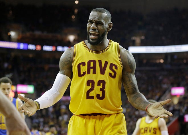 Cleveland Cavaliers forward LeBron James (23) questions a call during the first half of Game 4 of basketball's NBA Finals against the Golden State Warriors in Cleveland, Thursday, June 11, 2015. (AP Photo/Tony Dejak)