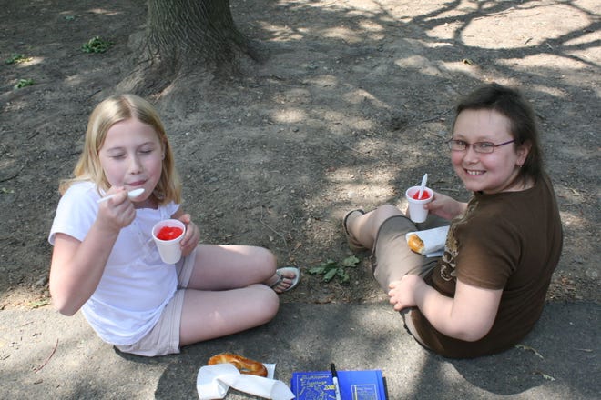 Ally (left) and her friend Jules enjoy some water ice and pretzels in fourth grade, about a year and a half after Jules had begun treatment for leukemia.