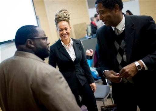 In this Jan. 16, 2015, file photo, Rachel Dolezal, center, Spokane's newly-elected NAACP president, smiles as she meets with Joseph M. King, of King's Consulting, left, and Scott Finnie, director and senior professor of Eastern Washington University's Africana Education Program, before the start of a Black Lives Matter Teach-In on Public Safety and Criminal Justice, at EWU, in Cheney, Wash. Dolezal's family members say she has falsely portrayed herself as black for years. Photo by Tyler Tjomsland/The Spokesman-Review