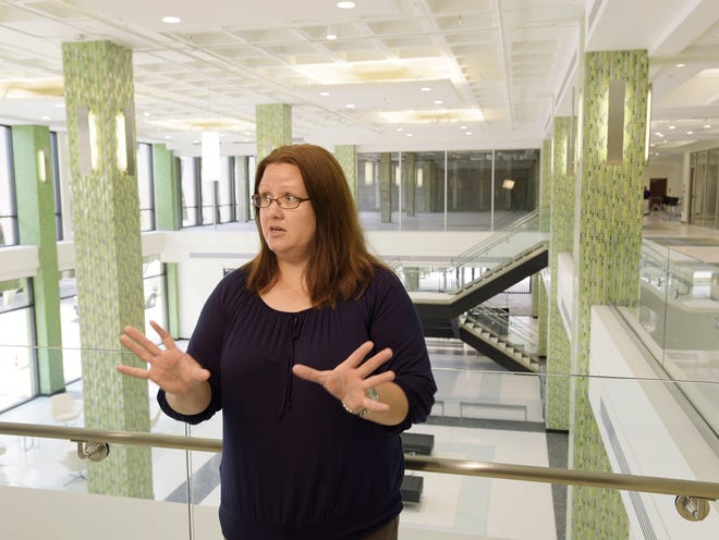 Brooke Robbins describes the work area on the 1st floor of the center that still features some of the mosaic tile walls from the original building.