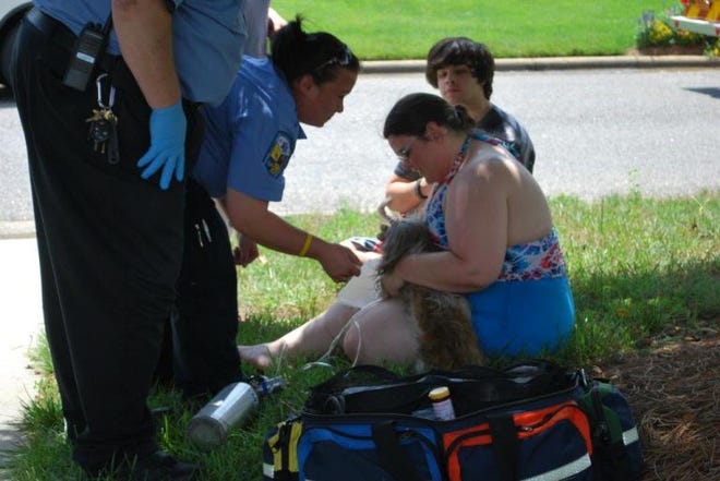 Dallas Rescue emergency medical technicians administers oxygen to a dog saved from a Gastonia house fire while the homeowner holds it. Photo Courtesy of the Gastonia Fire Department. Photo Courtesy of the Gastonia Fire Department.