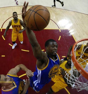 Golden State Warriors forward Harrison Barnes goes up for a dunk against the Cleveland Cavaliers during the first half of Game 4 of the NBA Finals in Cleveland on Thursday. Golden State rallied to beat Cleveland, 103-82, and tie the Finals at 2-2.