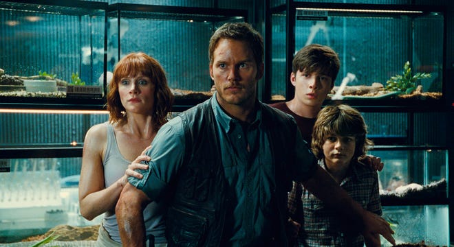 This photo provided by Universal Pictures shows, Bryce Dallas Howard, from left, as Claire, Chris Pratt as Owen, Nick Robinson as Zach, and Ty Simpkins as Gray, in a scene from the film, "Jurassic World," directed by Colin Trevorrow, in the next installment of Steven Spielberg's groundbreaking "Jurassic Park" series. The Universal Pictures 3D movie releases in theaters on June 12, 2015. (Universal Pictures/Amblin Entertainment via AP)