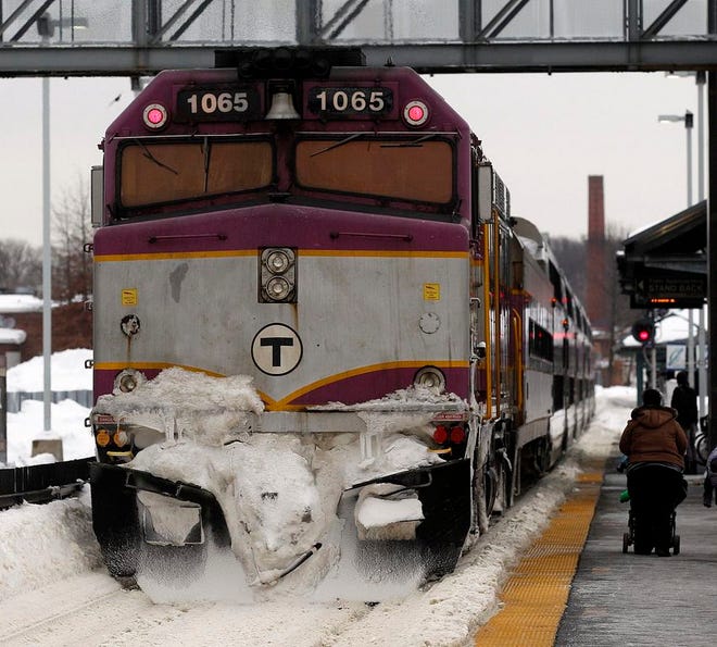 An ice-covered commuter train leaves Framingham Station on Waverly Street in this file photo from February 2015. (Daily News staff photo/Marshall Wolff)