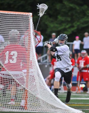 Duxbury's Niall Dillon takes a shot and scores during the first half of the South Sectional lacrosse final against Catholic Memorial Friday, June 12, 2015, held at Norwell High School.