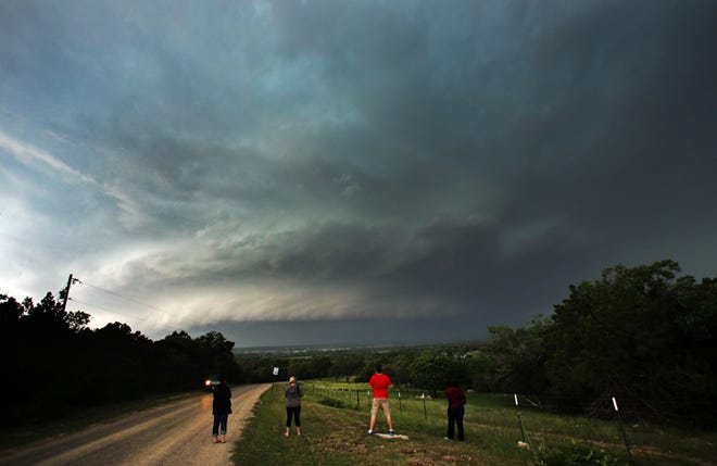 From left, Ashleigh DeVries, Shanda Hinnant, Alec Scholten and Val Namen watch a tornado-warned storm near Clifton, Texas on Sunday, May 10, 2015. (Brittany Randolph/The Star)