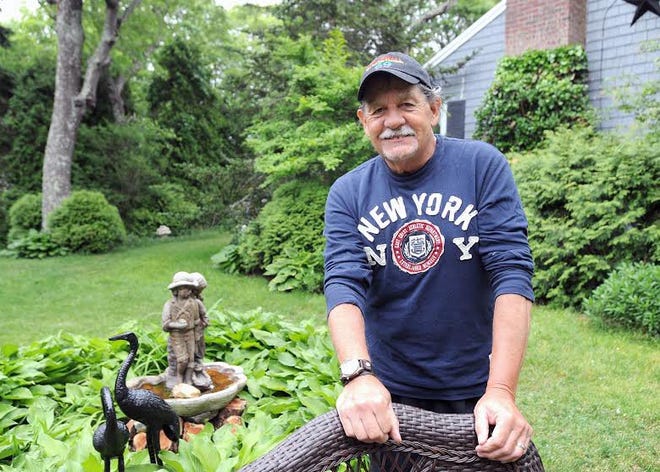 Stonewall veteran David Velasco Bermudez in front of his Yarmouth Port home. Staff photo by Dave Colantuono
