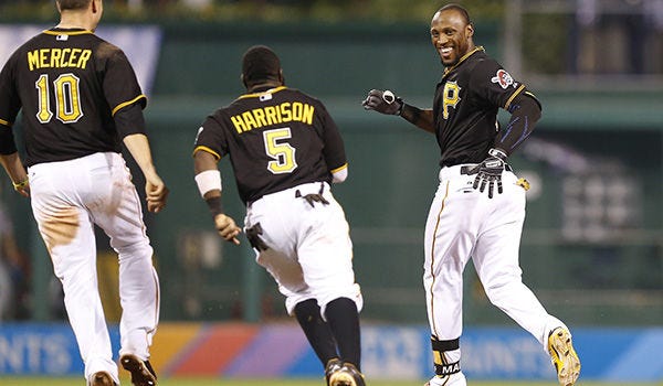 Pirates' Starling Marte, right, runs away from teammates Josh Harrison (5) and Jordy Mercer (10) as they chase him to celebrate after Marte drove in the game-winning run in the bottom of the 13th inning against the Phillies early Saturday in Pittsburgh. The Pirates won 1-0 in 13 innings.