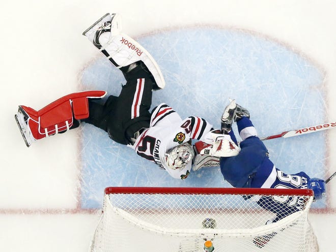 Tampa Bay right wing Nikita Kucherov (86) hits the goal post as he collides with Chicago goalie Corey Crawford (50) during the first period of Saturday's Game 5 of the Stanley Cup Final.