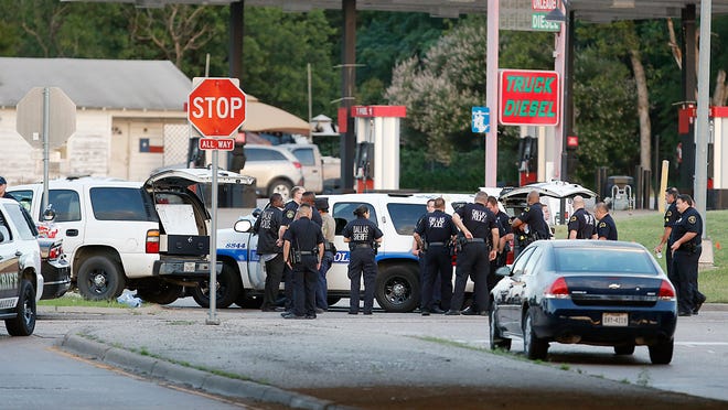 Police block the intersection of Dowdy Ferry Rd and Interstate 45 during a standoff with a gunman barricaded inside a van.