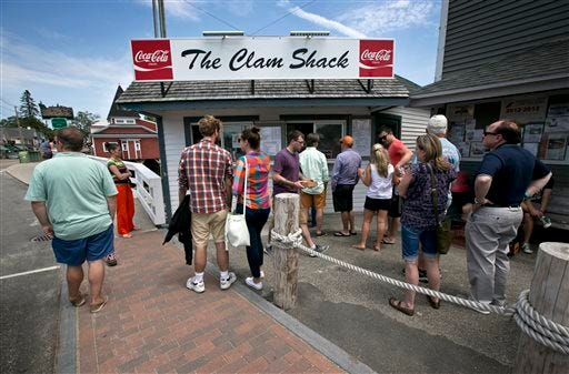 Customers line up to order seafood at the Clam Shack in Kennebunkport, Maine, Friday, June 12, 2015. Early in the season many of the lobsters that are sold in Maine are "shedders," lobsters that recently shed their shells. (AP Photo/Robert F. Bukaty)