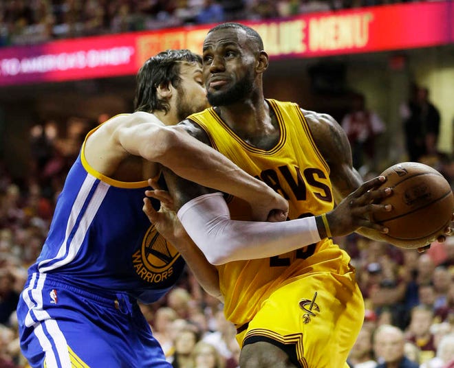 Golden State Warriors center Andrew Bogut, tries to tie up Cleveland Cavaliers forward LeBron James during Game 4 of the NBA Finals on Thursday in Cleveland. (AP Photo/Tony Dejak)