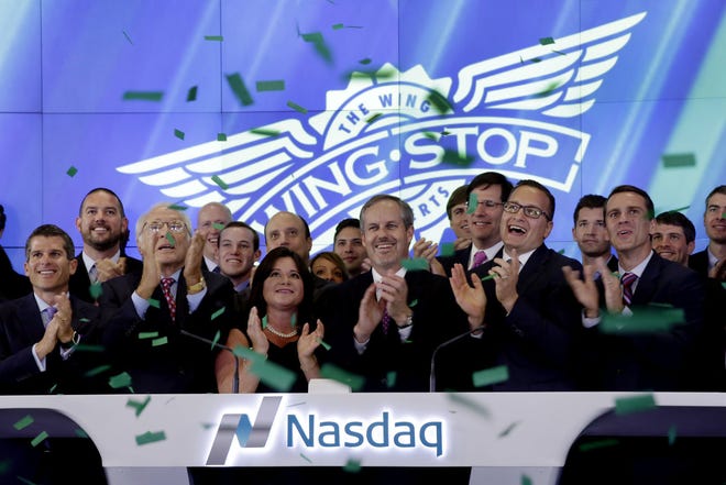 AP Photo/Richard Drew Wingstop President andamp; CEO Charles Morrison, center, is joined in applause during opening bell ceremonies at the Nasdaq MarketSite, to mark his company's IPO, in New York's Times Square, Friday, June 12, 2015. Wingstop is a leading franchisor and operator of restaurants that specialize in cooked-to-order, hand-sauced and tossed chicken wings.