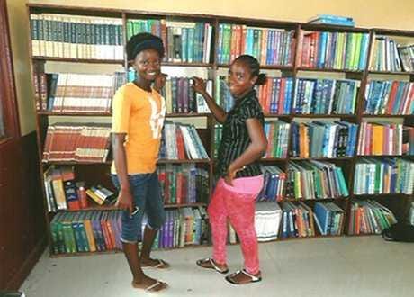 Provided by the Bong Education Center Alumni Association Two students stand in the library of Bong Mines Central High School, the successor to a school destroyed in the country's civil wars.