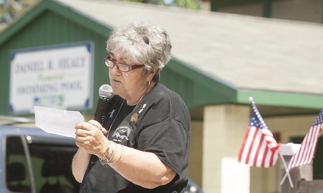 Natalie Healy, the mother of Navy Seal Dan Healy, who was killed in Afghanistan, reads a letter sent in memory of her son at the memorial for him at the Daniel R. Healy Outdoor Pool, Sunday in  Exeter.

Photo by Amy Donle/Seacoastonline