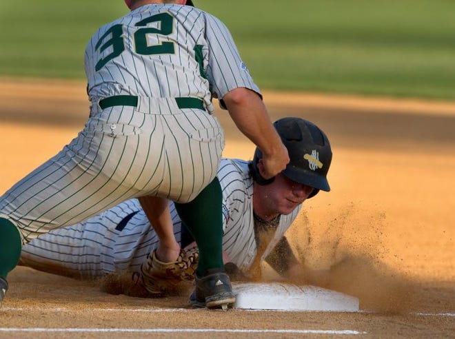 Gastonia's Brennan Morgan slides back to first base, covered by Forest City's Zack Canada during Monday's game.