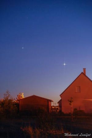 Here’s what most of us will see if we look west tonight. Venus (brighter, below) and Jupiter are very bright – the two brightest starlike objects in the sky. Venus and Jupiter on June 9, 2015 from Mohamed Laaifat Photographies in Normandy, France. (Photo courtesy of Earthsky.org)