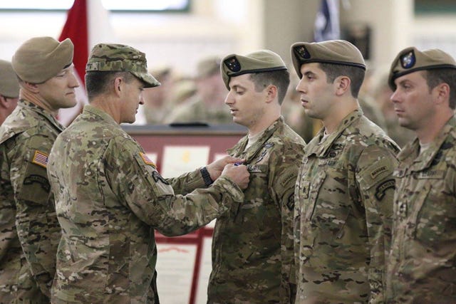 Army Vice Chief of Staff Gen. Daniel Allyn presents the Silver Star to Swansboro graduate Staff Sgt. James Jones during a ceremony at Hunter Army Airfield, Georgia.
