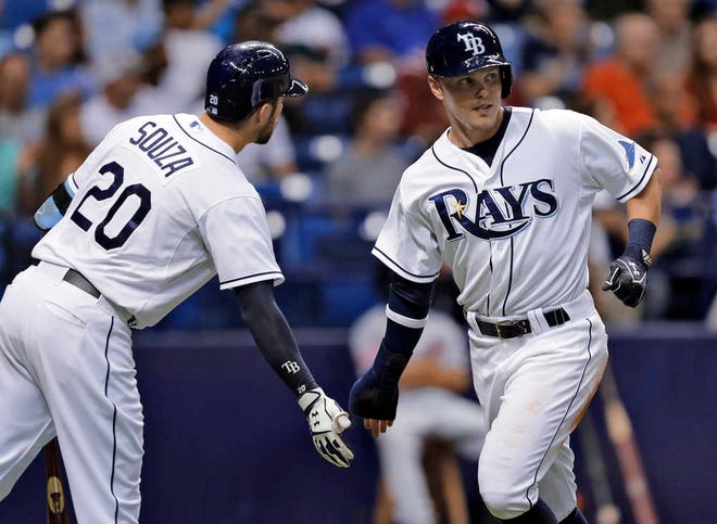 Tampa Bay Rays' Brandon Guyer, right, shakes hands with Steven Souza Jr. after scoring on an RBI single by Logan Forsythe off Washington Nationals starting pitcher Gio Gonzalez during the fourth inning of an interleague baseball game Monday, June 15, 2015, in St. Petersburg, Fla. (AP Photo/Chris O'Meara)