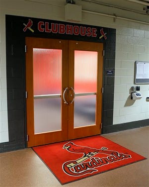 The doors of the St. Louis Cardinals clubhouse are closed before a scheduled baseball game against the Minnesota Twins, Tuesday, June 16, 2015, in St. Louis. Major League Baseball says it is cooperating with a federal investigation into an illegal breach of the Astros' internal operations database, amid a report that the Cardinals were responsible for the hack. The New York Times, citing unnamed law enforcement officials, reported Tuesday, June 16, 2015 , that the FBI and Justice Department are investigating whether Cardinals' front-office officials are responsible for the effort to steal information about player personnel. The The teams were rivals in the National League Central until Houston moved to the American League in 2012. (AP Photo/Scott Kane)