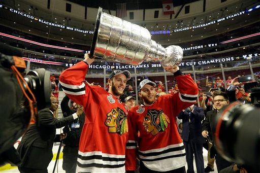 Chicago's Jonathan Toews and Patrick Kane celebrate after defeating the Tampa Bay Lightning in Game 6 of Stanley Cup Final on Monday. AP photo