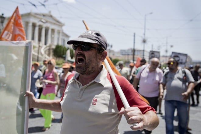 A MUNICIPAL WORKER  protests against handing over the garbage collection to private contractor in Athens on Tuesday. Greece failed to reach a breakthrough in weekend bailout talks.
