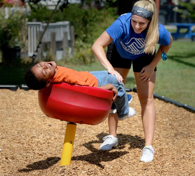 Staff counselor Jessica Garber spins Isaiah Brooks, 8, on the playground at the Boys & Girls Clubs of Lakeland & Mulberry at the James L. Musso Club in Lakeland on Tuesday.