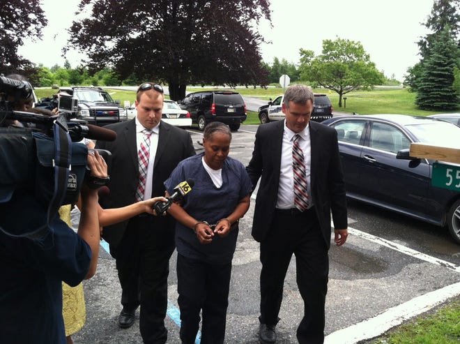 Pocono Mountain Regional Police detectives escorted Judith Marc of Tobyhanna to her Tuesday afternoon district court preliminary hearing on charges of murdering an elderly man in her care. (Andrew

Scott/Pocono Record)
