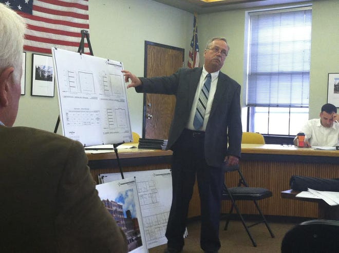 Architect Andrew Philip Roth presents different building plans for a proposed apartment building on the 600 block of Main Street in Stroudsburg. (Kevin Kunzmann/Pocono Record)