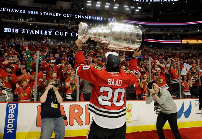 Chicago Blackhawks' Brandon Saad holds up the Stanley Cup after defeating the Tampa Bay Lighning in Game 6 on Monday in Chicago. The Blackhawks defeated the Lightning 2-0 to win the series 4-2. (AP Photo/Nam Y. Huh)
