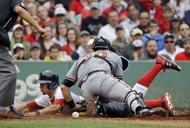 Atlanta's Ryan Lavarnway cannot handle the throw as Boston's Mookie Betts slides into home to score on a single by Xander Bogaerts in the sixth inning. The Associated Press