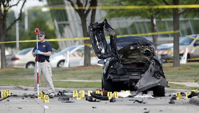 FBI crime scene investigators document evidence outside the Curtis Culwell Center in Garland, Texas, in May. A Phoenix-area man has been charged with helping plan the attack on a provocative Texas cartoon contest featuring depictions of the Prophet Muhammad that ended with the two shooters' deaths last month.