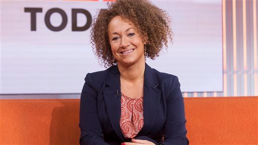 In this image released by NBC News, former NAACP leader Rachel Dolezal appears on the "Today" show set on Tuesday, June 16, 2015, in New York. Dolezal, who resigned as head of a NAACP chapter after her parents said she is white, said Tuesday that she started identifying as black around age 5, when she drew self-portraits with a brown crayon, and "takes exception" to the contention that she tried to deceive people. Asked by Matt Lauer if she is an "an African-American woman," Dolezal said: "I identify as black." (Anthony Quintano/NBC News via AP)