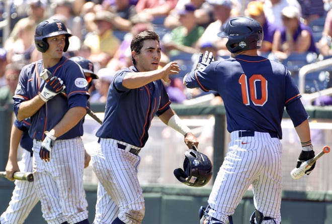 AP Photo/Mike Theiler Cal State Fullerton's Jerrod Bravo, center, is greeted by A.J. Kennedy (10), after scoring on a sacrifice bunt by Dalton Blaser, in the first inning of an NCAA College World Series baseball elimination game against LSU at TD Ameritrade Park in Omaha, Neb., Tuesday, June 16, 2015.